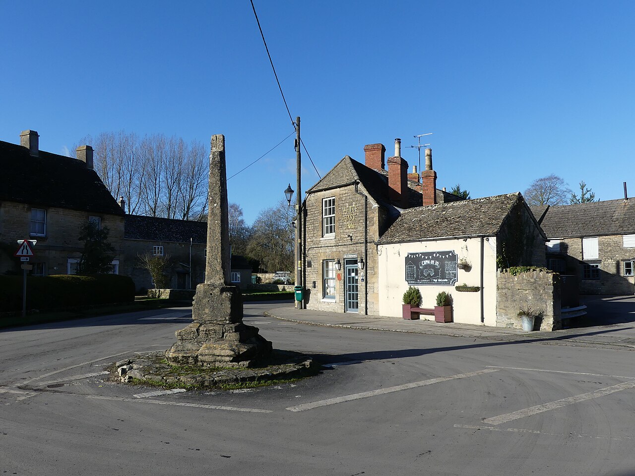 The village pub, with Mediaeval preaching cross, Ashton Keynes