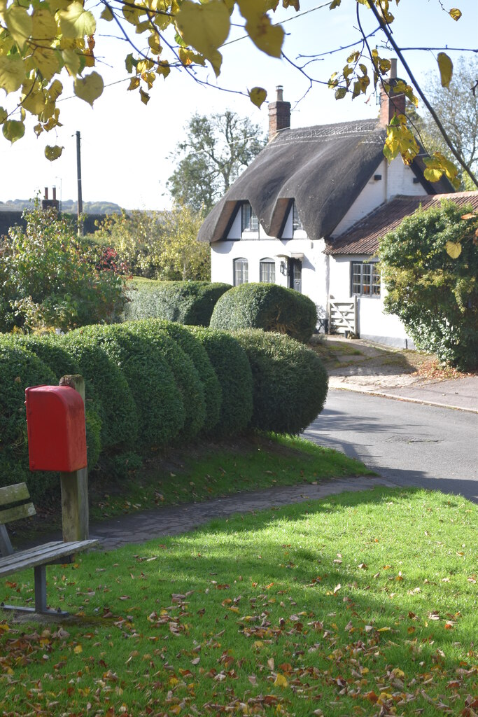 Thatched cottage and post box at Easton Cross Roads