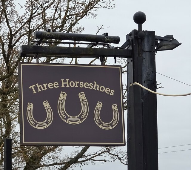 Sign for the Three Horseshoes public house