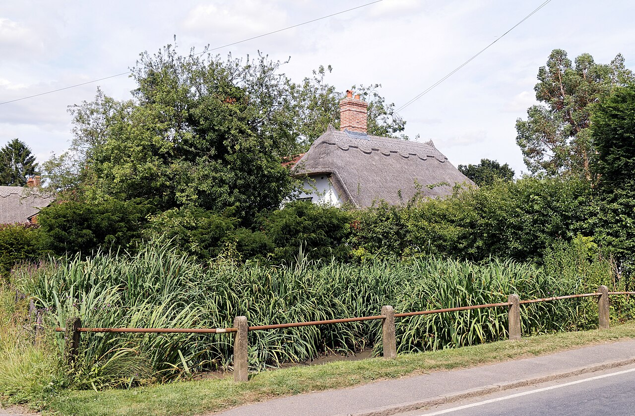 Concrete post fence and house, High Street Henham Essex England