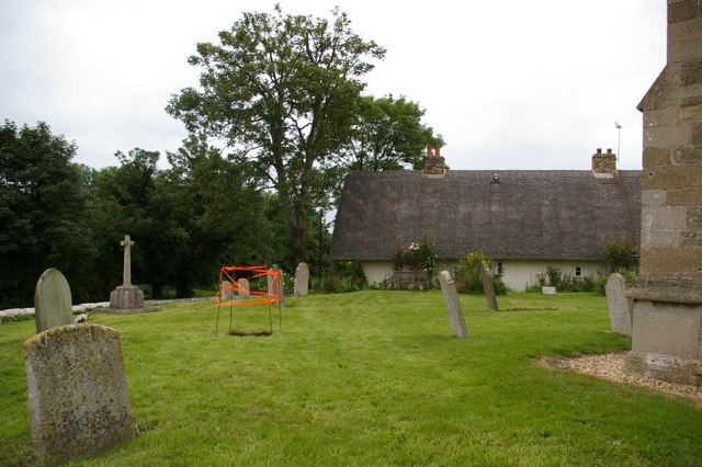 St Peter's churchyard with view to thatched cottage beyond